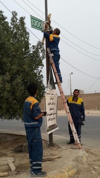 تعویض تابلوهای «شماره عمود» مسیر کربلا توسط خادمان ایرانی + تصاویر